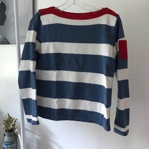 Blue and white sweater with red accents.